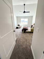 Carpeted bedroom with ceiling fan and a textured ceiling