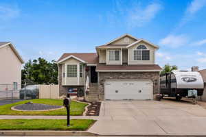 View of front of house with a garage and a front yard