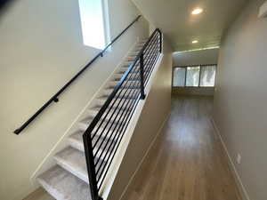 Stairs featuring hardwood / wood-style floors