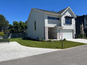 View of front of home featuring a garage and a front lawn