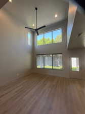 Interior space featuring ceiling fan, a wealth of natural light, and wood-type flooring