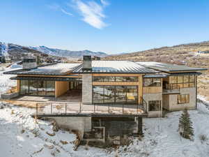 Snow covered house featuring a mountain view