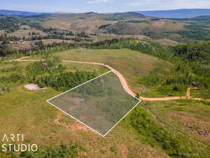 Birds eye view of property with a mountain view and a rural view