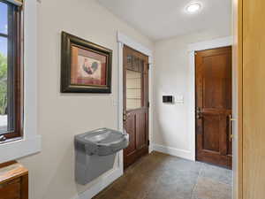 Mudroom with tile, half bath, and drinking fountain