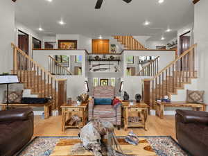 Living room with ceiling fan and hardwood flooring