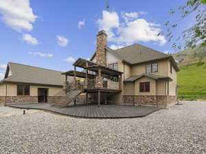 Rear view of property featuring a wooden deck