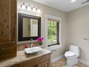 Master bathroom featuring tile flooring, vanity, and toilet