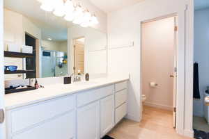 Bathroom featuring oversized vanity and toilet