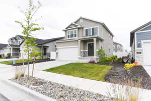 Craftsman-style home with a garage and a front lawn