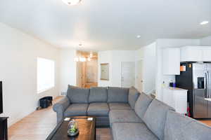 Living room featuring a notable chandelier and hardwood / wood-style flooring