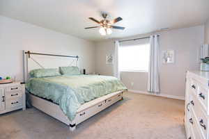 Bedroom with light carpet and ceiling fan