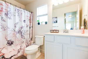 Bathroom featuring vanity and toilet