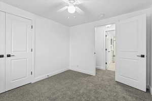 Unfurnished room with ceiling fan and carpet floors