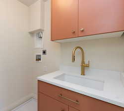 Laundry area featuring sink, washer hookup, electric dryer hookup, and cabinets