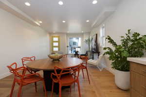 Dining space featuring a healthy amount of sunlight and light hardwood / wood-style flooring