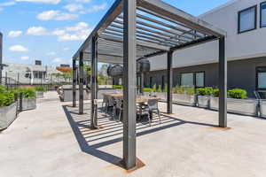 Community patio space dining area and grill