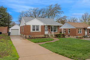 View of front of house with the detached garage, front yard.