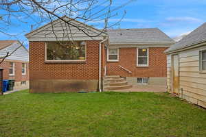 Back of house featuring a yard