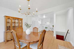 Dining space featuring an inviting chandelier and light hardwood flooring