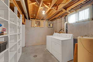 Laundry room featuring washer and clothes dryer, lost of storage