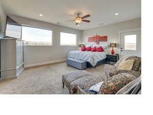 Bedroom with carpet, multiple windows, and ceiling fan