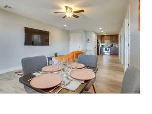 Dining space featuring ceiling fan and light hardwood / wood-style floors