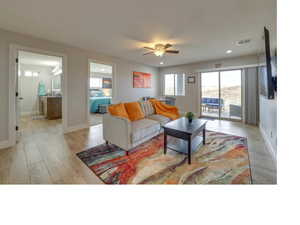 Living room featuring ceiling fan and light hardwood / wood-style floors