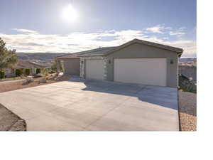 View of front of house featuring a garage and a mountain view