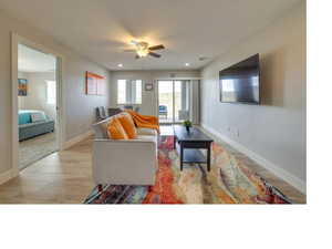 Living room featuring ceiling fan and light wood-type flooring