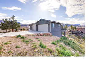 View of front of house with a garage and a mountain view