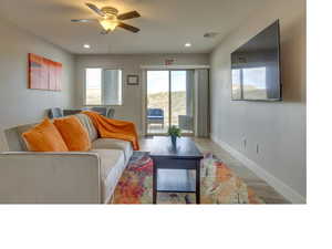 Living room with hardwood / wood-style floors and ceiling fan