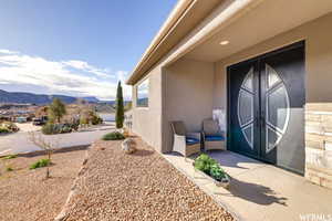 Property entrance featuring a patio area, french doors, and a mountain view