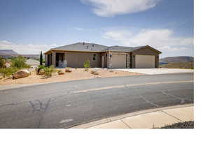 View of front facade with a garage and a mountain view