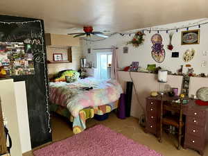 Bedroom with ceiling fan and concrete floors