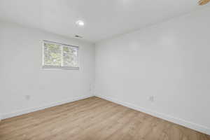 Spare room with light wood-type flooring