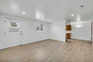 Unfurnished living room with light wood-type flooring