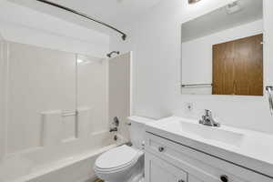 Full bathroom featuring shower / tub combination, large vanity, and toilet