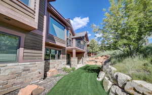 View of yard featuring a balcony