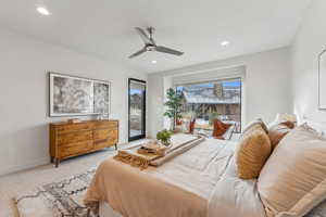 Carpeted bedroom with access to outside and ceiling fan