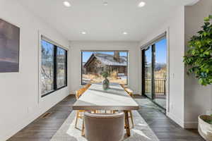 Dining room with dark hardwood / wood-style floors