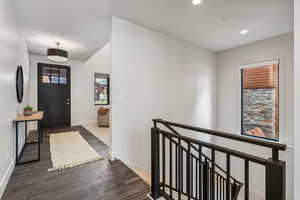 Entrance foyer with dark hardwood / wood-style floors