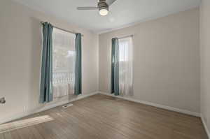 Spare room featuring ceiling fan and light wood-type flooring