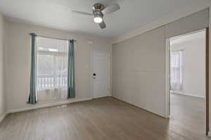 Spare room with light hardwood / wood-style flooring and ceiling fan