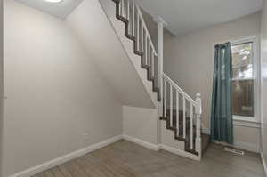 Staircase with hardwood / wood-style floors