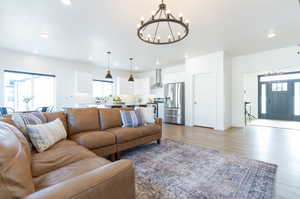 Living room with an inviting chandelier and light LVP flooring