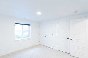 Unfurnished bedroom featuring light carpet