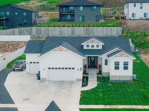 View of front of home featuring a garage and a front yard