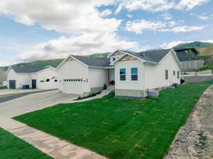 View of front of house featuring a garage and a front yard