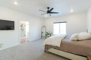 Bedroom featuring ceiling fan, carpet floors, and connected bathroom