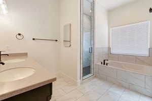 Primary Bathroom featuring tile flooring, double sink vanity, and plus walk in shower